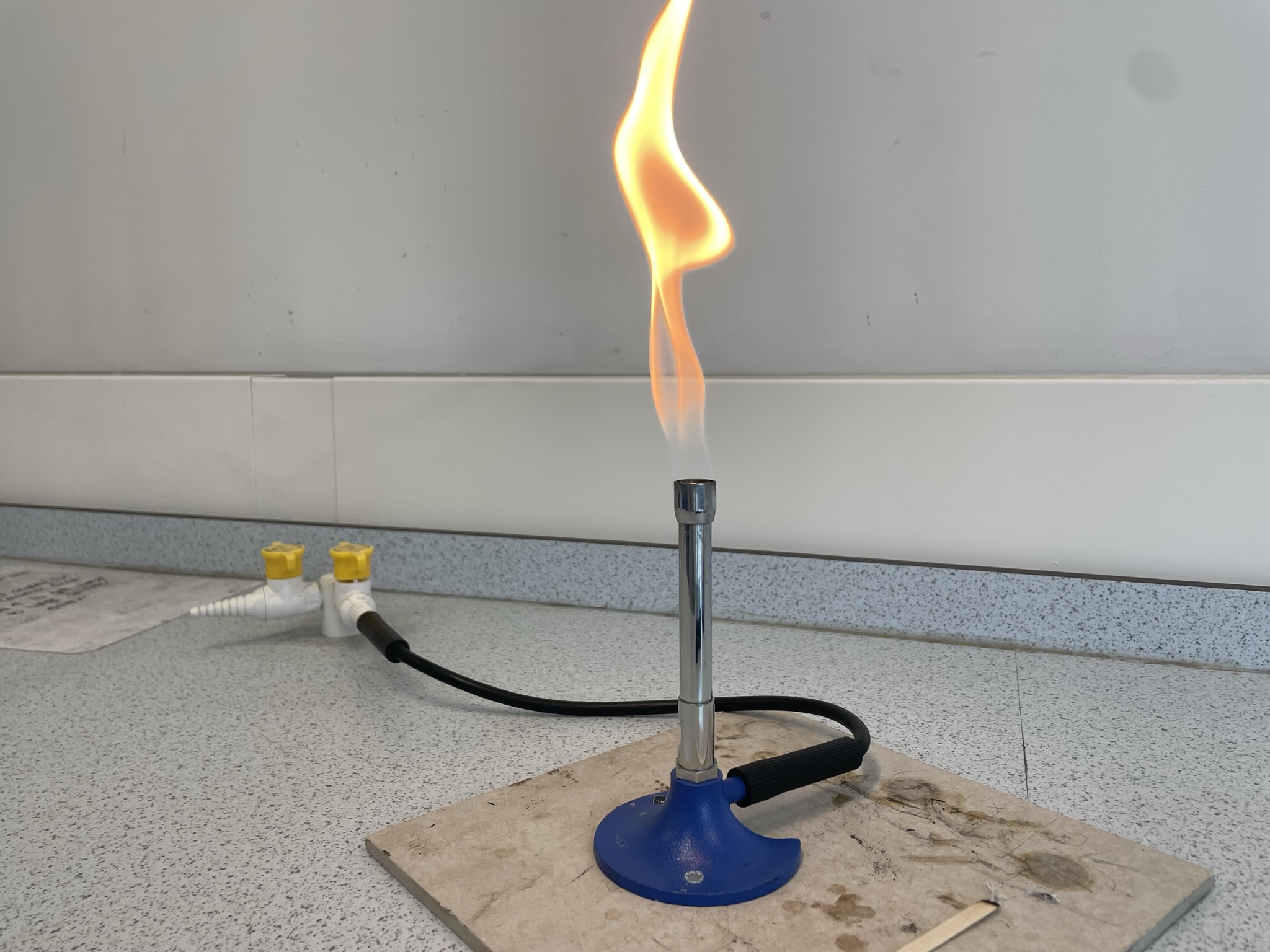 a Bunsen burner with an orange (safety) flame (air hole fully closed)